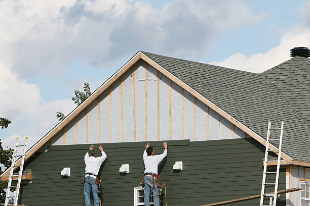Professional Siding technician working in Saint James, NY